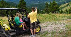 A family enjoys the summer view on an ATV ride