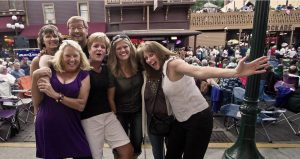 A group of people all standing close together and leaning into each other for a photo.