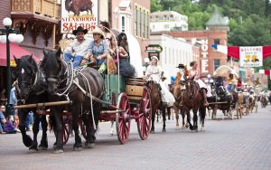 Traditional clothing is wore during the Days of 76 parade down the street in Historic Deadwood