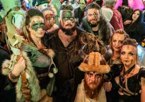 People dressed in Viking Halloween costumes stare into the camera ominously.