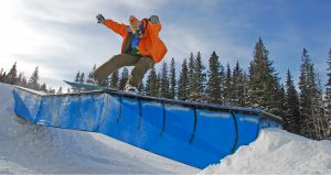 A snowboarder catches some air at terry peak ski area