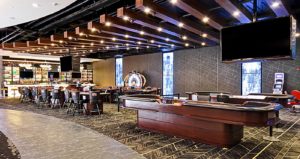 Interior of a casino area with a craps tables.