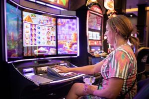 Lady playing slots in Cadillac Jacks