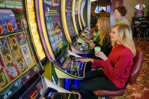 Women laughing while playing slots at The Lodge at Deadwood