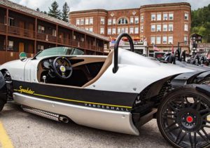 A grey Speedster three-wheeler parked in a row with other three-wheelers behind it.