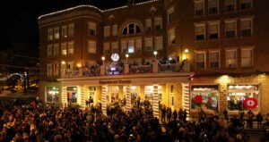 People stand in the street in front of the Historic Franklin Hotel for New Year's Eve in Deadwood, SD.