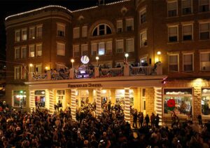 People stand in the street in front of the Historic Franklin Hotel for New Year's Eve in Deadwood, SD.