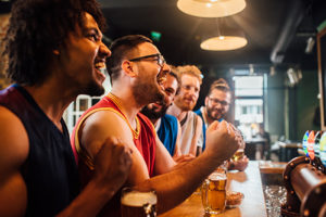 Guys cheering at a sports bar