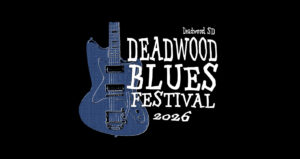 Deadwood Blues Fest logo with a blue electric guitar and white text in an informal font.