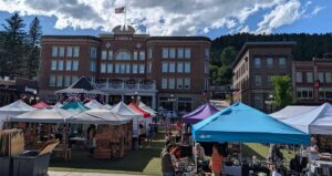 Multi-colored vendor tents in Outlaw Square during the annual Fair in the Square with the Historic Franklin Hotel in the background.