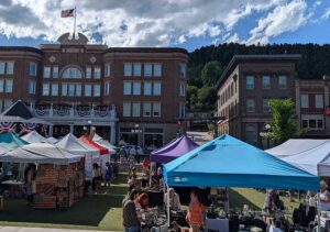 Multi-colored vendor tents in Outlaw Square during the annual Fair in the Square with the Historic Franklin Hotel in the background.
